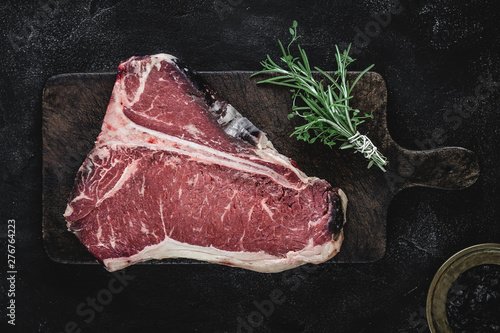 Dry Aged Beef Raw T-bone Steak on Vintage Cutting Board