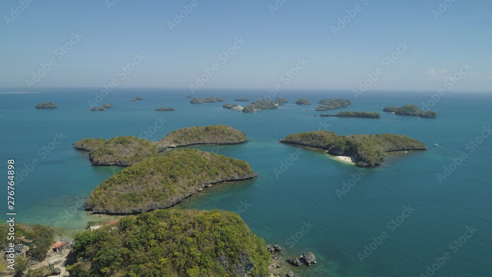 Aerial view of Small islands with beaches and lagoons in Hundred Islands National Park, Pangasinan, Philippines. Famous tourist attraction, Alaminos.