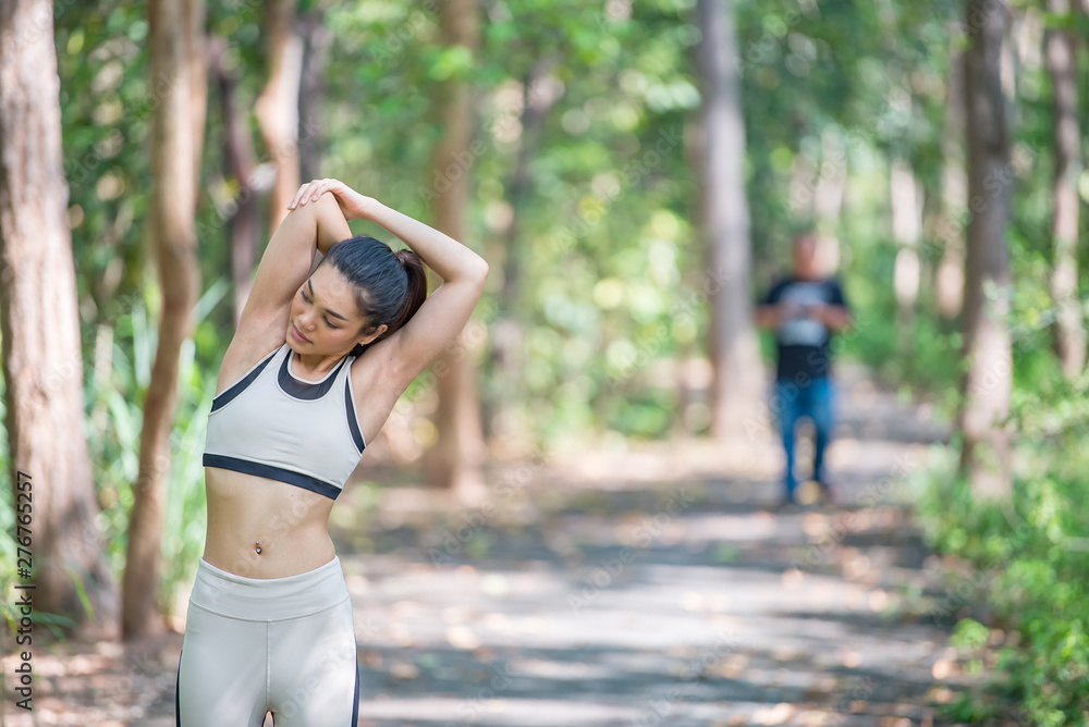 Asian sporty woman stretching body breathing fresh air in the park,Thailand people,Fitness and exercise concept,Jogging in the park Asian sporty woman stretching body breathing fresh air in the park,Thailand people,Fitness and exercise concept,Jogging in the park