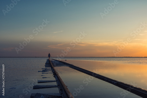 Woman at beauty sunset on s...