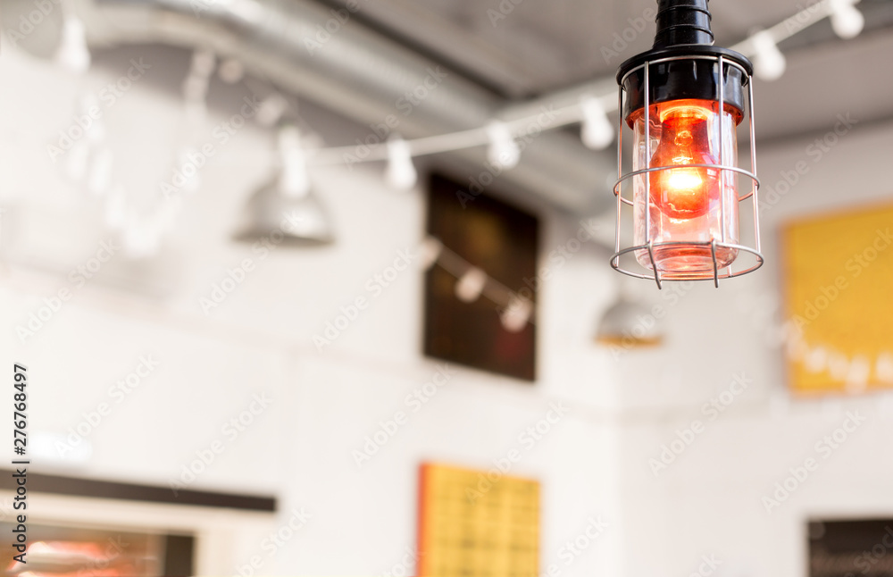 interior, light and decoration concept - close up of lamp or electric lantern at modern restaurant