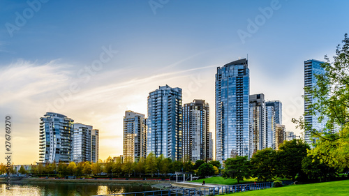 Sunset as the sun is setting behind modern Skyscapers lining the skyline of Yaletown along False Creek Inlet of Vancouver, British Columbia, Canada