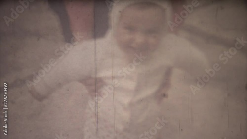 Family chronicle: Mother teach their child to walk. 8mm retro camera. photo