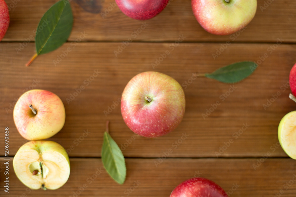 fruits, food and harvest concept - ripe red apples on wooden table fruits, food and harvest concept - ripe red apples on wooden table