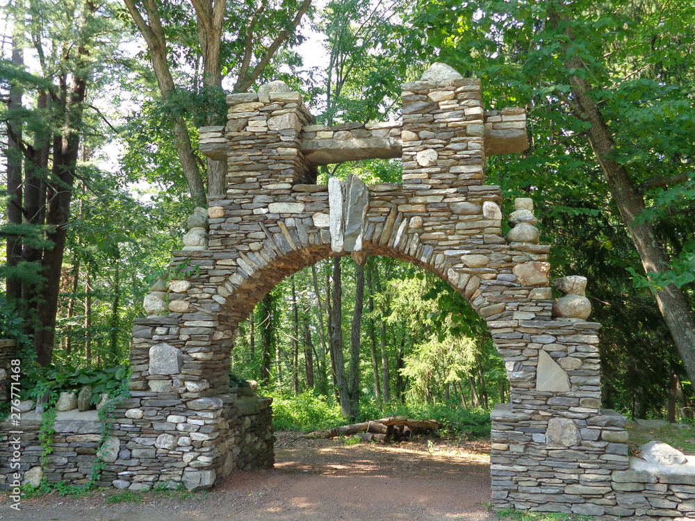 Unique stone archway over path in woods