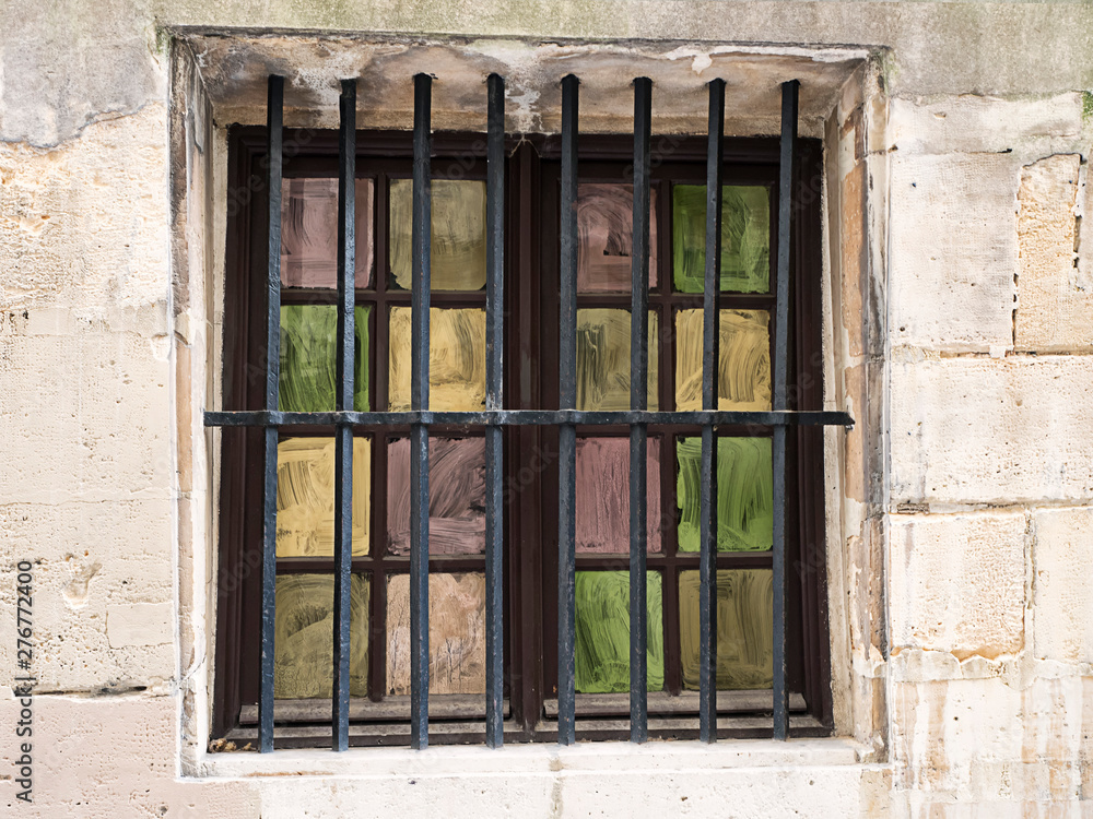 Obraz premium Painted and Barred Window in Stone Wall