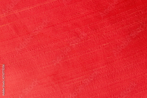 Close up of a woolen fabric of red scarlet color. Abstract canvas background, empty template.