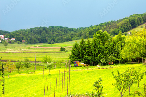 Beautiful summer farmland Slovenian landscape with colorfull and vibrant bee hives. Green meadow in Skofljica, Slovenia. photo