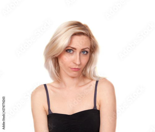 Portrait of a young bewildered blonde woman on a white background