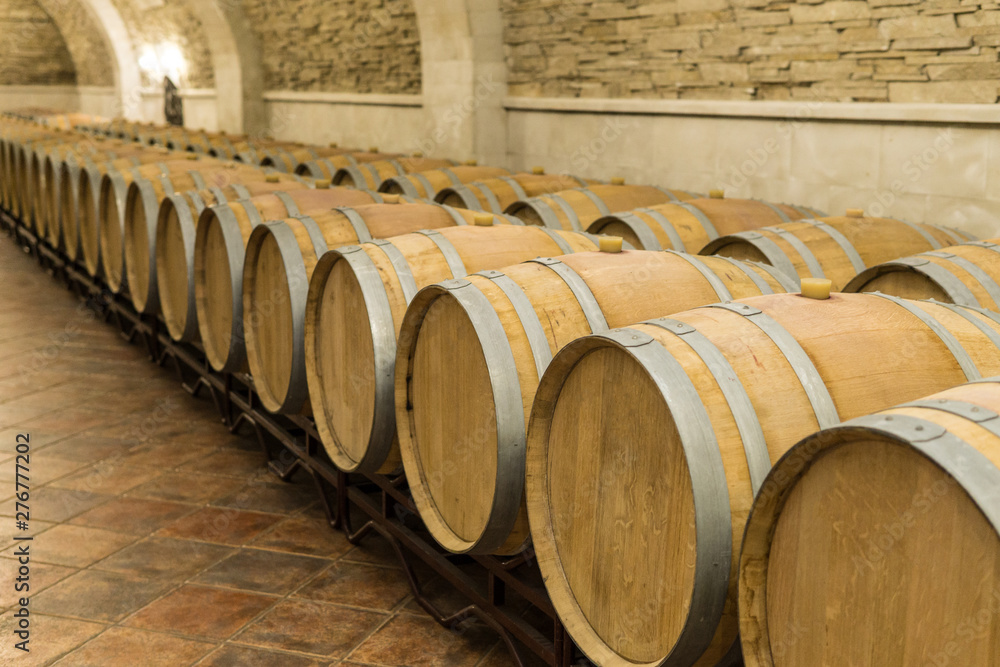 Wine barrels stacked in the cellar of the winery. Wine barrels in wine-vaults. Wine barrels stacked in the cellar of the winery. Wine barrels in wine-vaults.