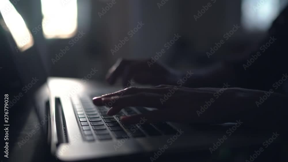 Hands on laptop computer keyboard typing text and using touchpad Stock