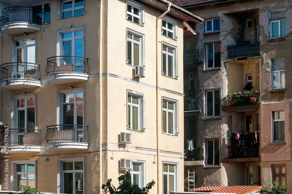 Fototapeta premium Urban renovated and neglected buildings closeup in sunny day
