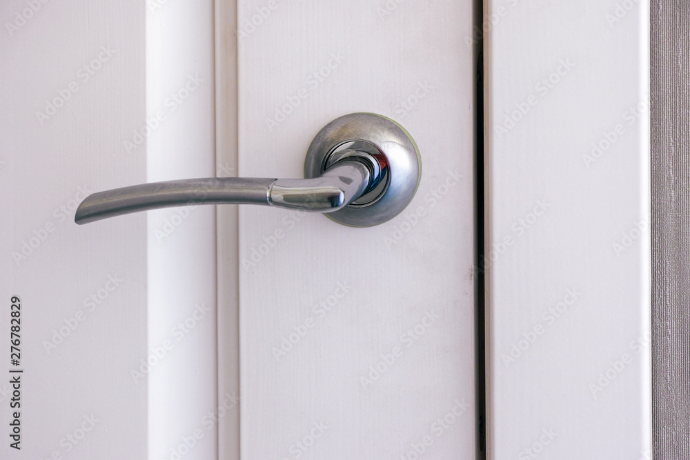 Closed white interroom door with handle. Closed white interroom door with handle.