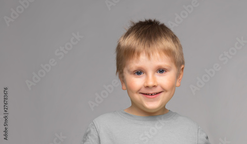Portrait of happy smiling boy. Attractive kid in studio.