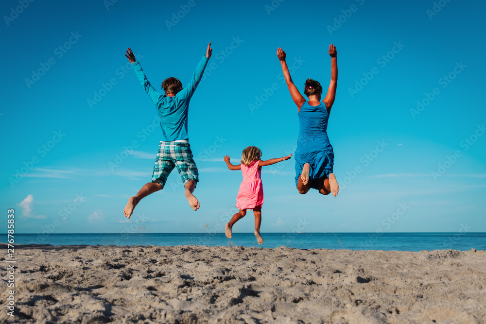 happy family- mom, dad and little daughter- jumping on beach happy family- mom, dad and little daughter- jumping on beach