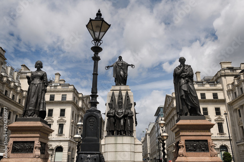 Monument to Florence Nightingale and Sidney Herbert Secretary at War for the Crimean War with lamp post and War Memorial Waterloo Place London England © Reimar