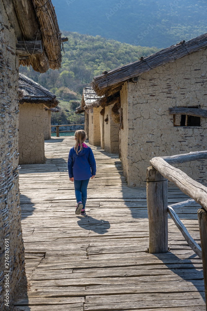 Little girl walking among houses in the Bay of Bones