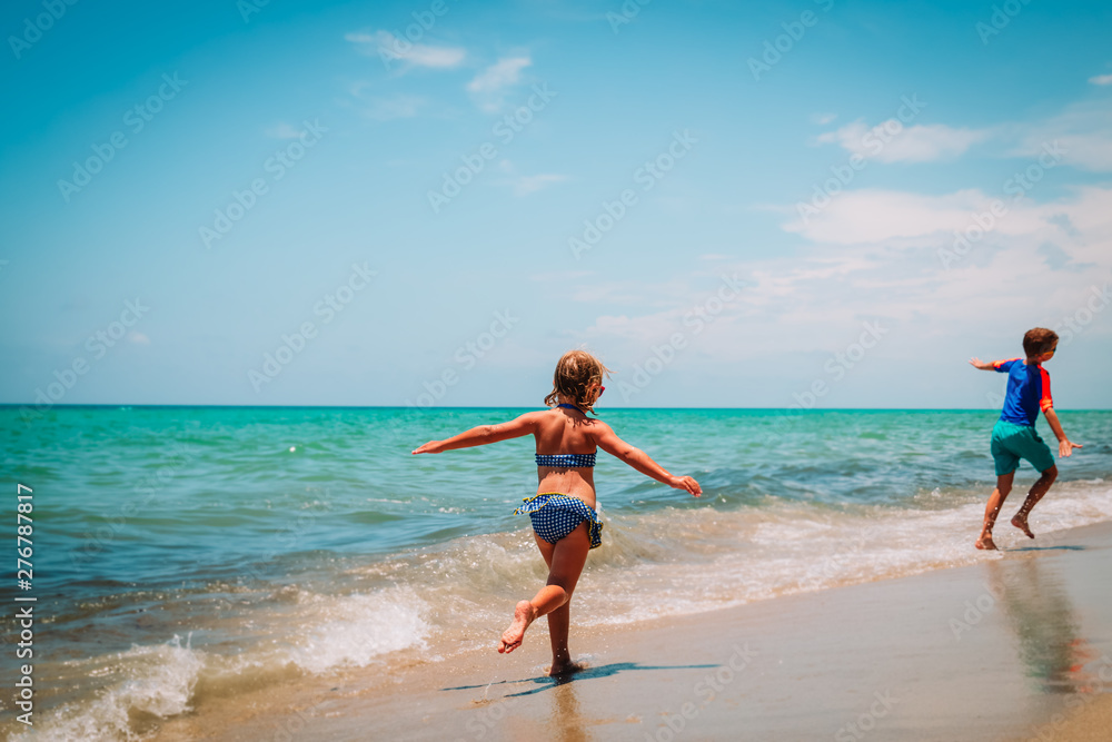 happy girl and boy running on beach happy girl and boy running on beach