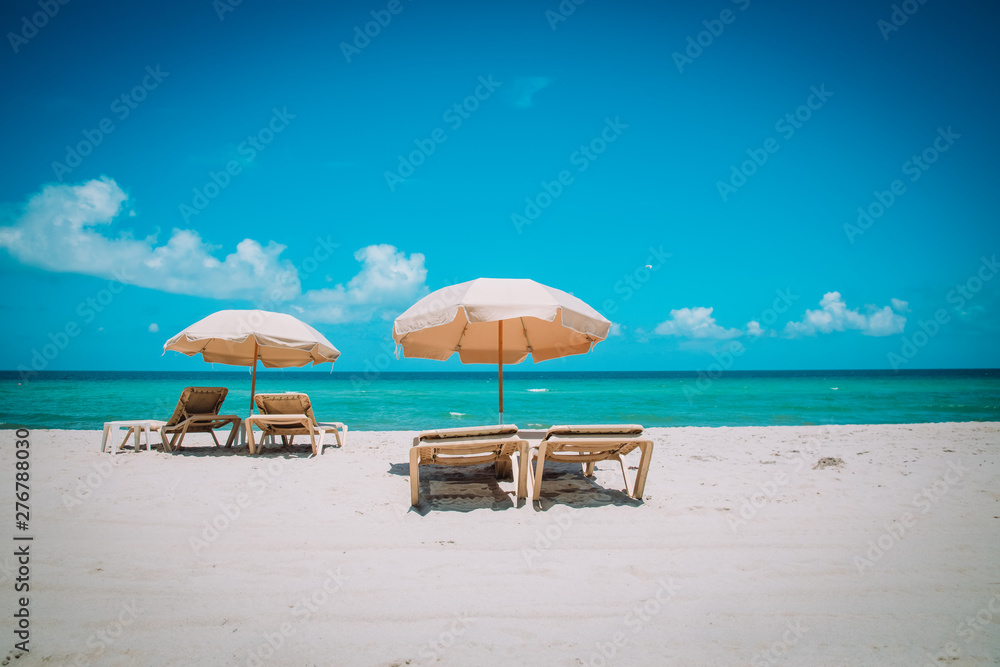 Beach chairs on tropical vacation, travel to sea concept