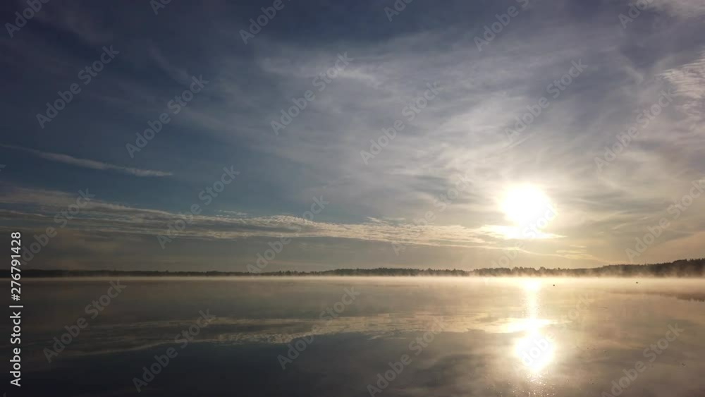 Panoramic view over a lake with mist during sunrise Panoramic view over a lake with mist during sunrise