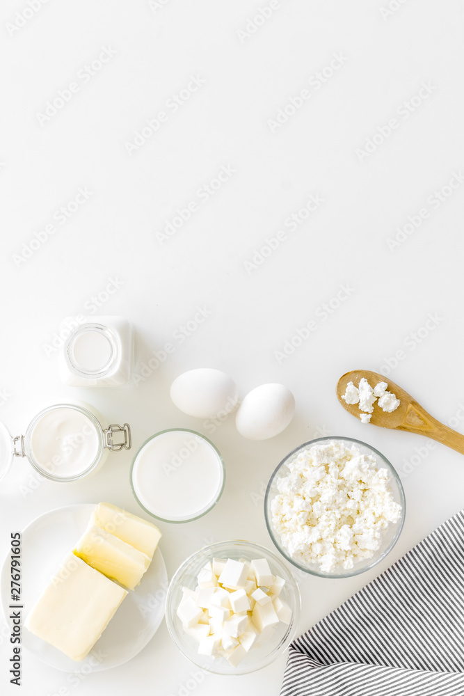 Fresh dairy products for breakfast with milk, cottage, eggs, butter, yougurt on white background top view mock up - obrazy, fototapety, plakaty 