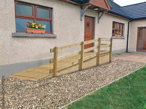 Wheelchair ramp over a step into house