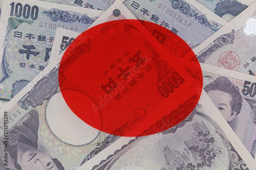 Yen banknotes and Japan flag