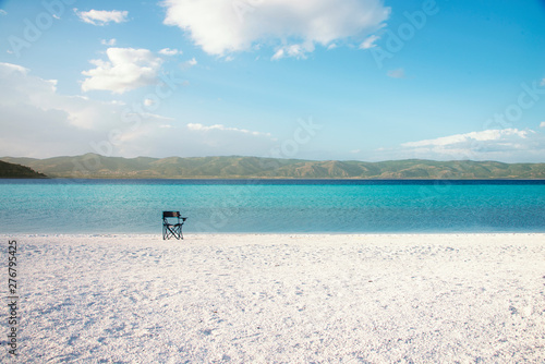 Fototapeta Naklejka Na Ścianę i Meble -  Salda lake like Maldives with white sand and turquoise colored water with an empty chair on the scene.