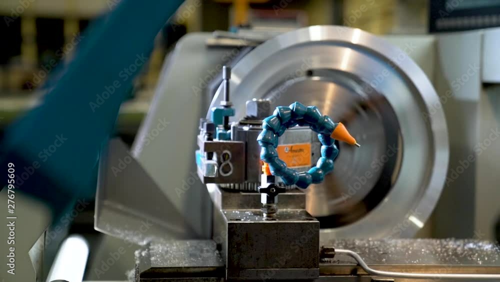 Metalworking steel gears by worker in a factory.