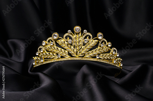 golden crown on a black silk