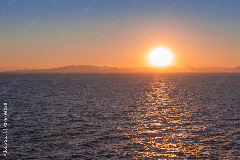 Beautiful sunset over the sea with islands of Saronic Gulf background Beautiful sunset over the sea with islands of Saronic Gulf background