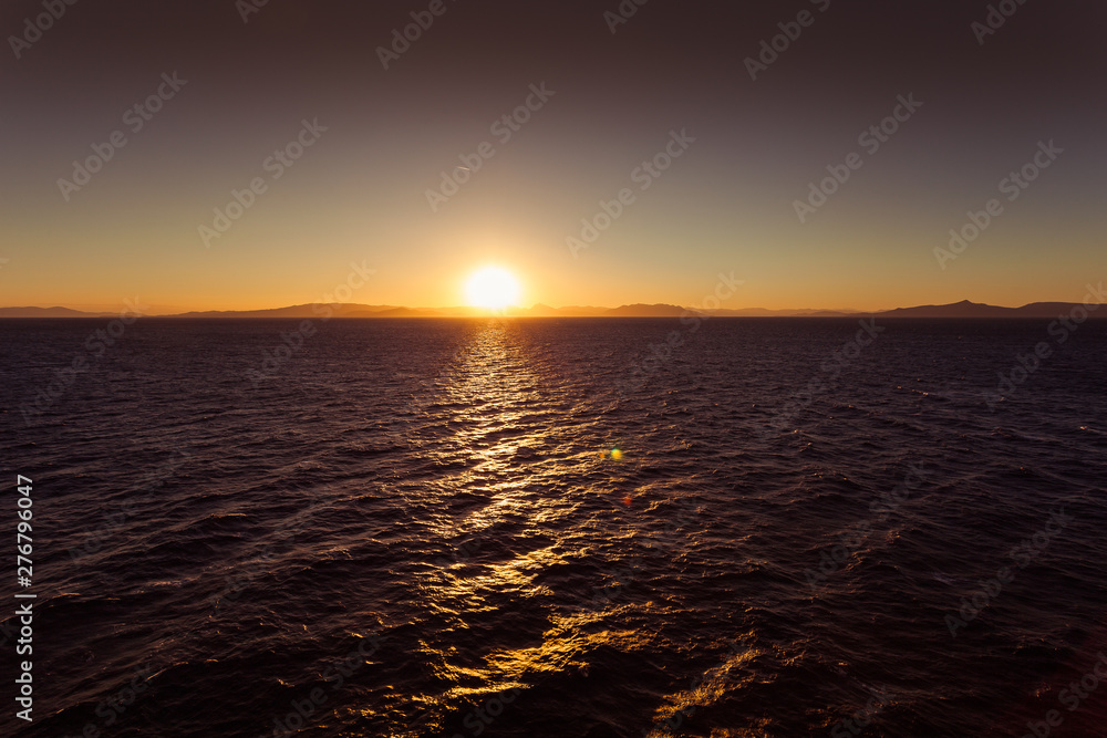 Awesome sunset over the sea with islands of Saronic Gulf background Awesome sunset over the sea with islands of Saronic Gulf background