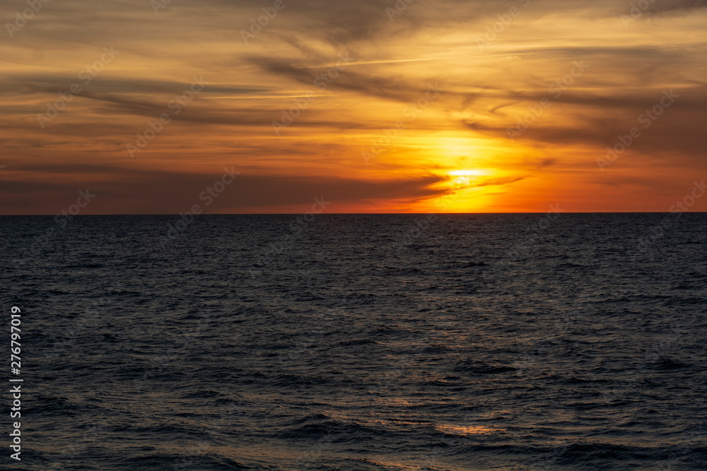 Beautiful fiery sunset sky on the beach. Sunrise over the sea and beautiful cloudscape. Beautiful fiery sunset sky on the beach. Sunrise over the sea and beautiful cloudscape.
