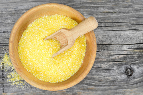 Top view of cornmeal in wooden bowl photo