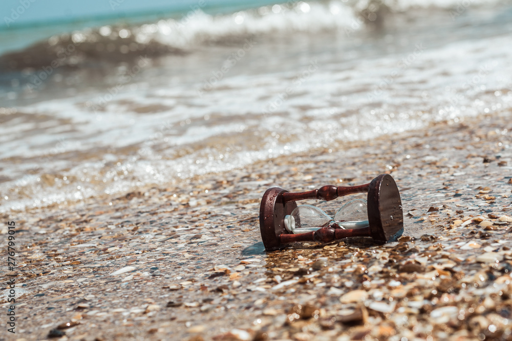 Hourglass on the beach, ocean. The concept of transience of time. Hourglass on the beach, ocean. The concept of transience of time.