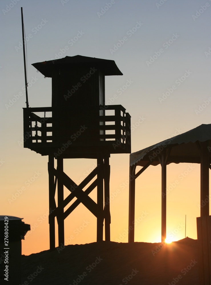 Sunset at the beach in the afternoon with vigilance tower Sunset at the beach in the afternoon with vigilance tower
