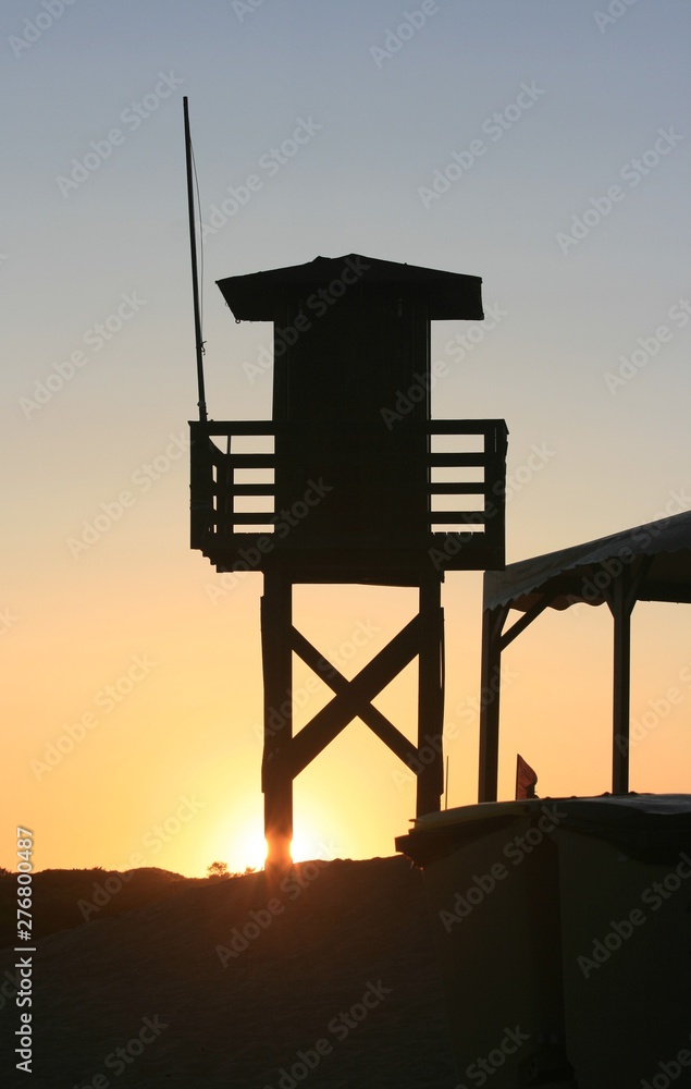 Sunset at the beach in the afternoon with vigilance tower Sunset at the beach in the afternoon with vigilance tower