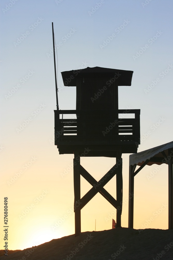 Sunset at the beach in the afternoon with vigilance tower Sunset at the beach in the afternoon with vigilance tower