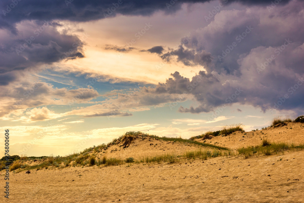 Sunlight in stormy cloudy sky on the beach