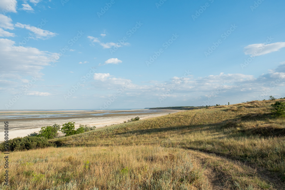 Lagoon estuary Molochnyi liman landscape grass path road clouds blue sky