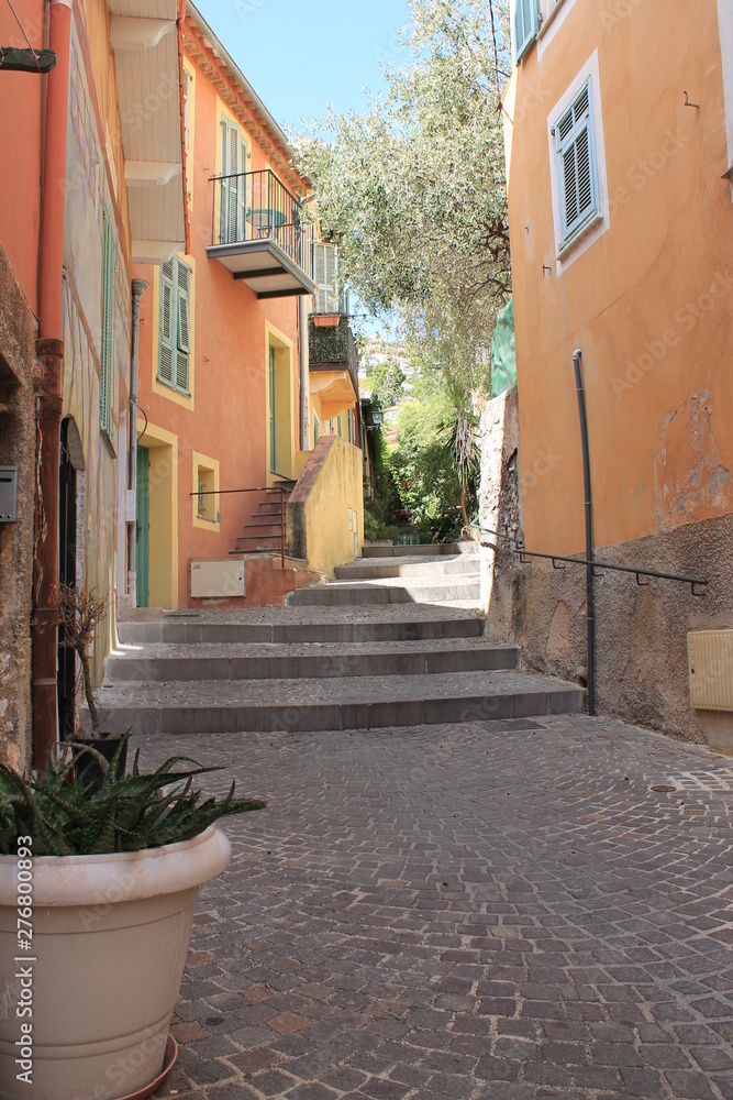 Colorful building lined cobblestone steps in old town Villefranche France