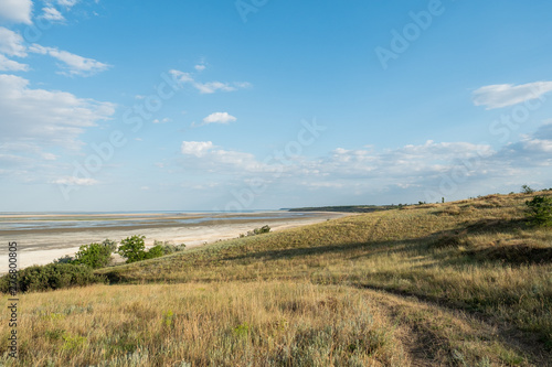Lagoon estuary Molochnyi liman landscape grass path road clouds blue sky