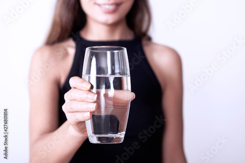young woman taking medicine pill with water