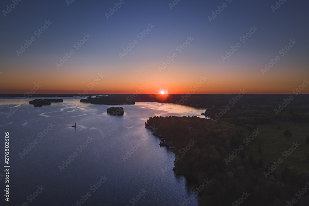 Drone/aerial image taken during sunset over Lake Muskoka. Located near Bracebridge, Ontario, Canada.