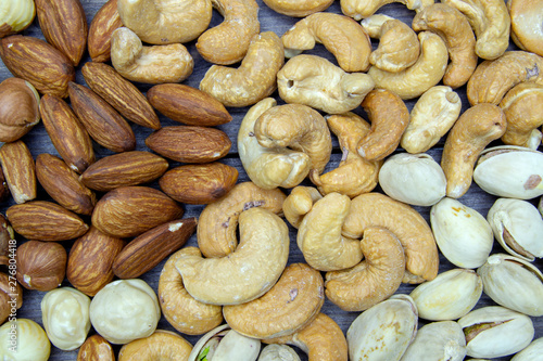 nuts almonds cashew hazelnuts scattered on a wooden table