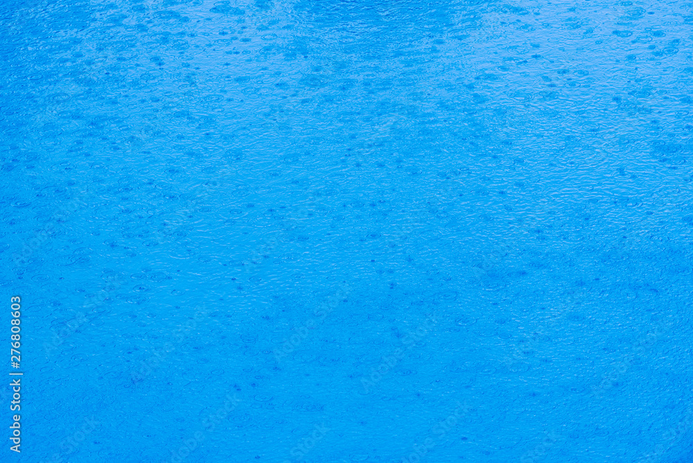 Image to use as background of rain falling on the water of a lake of transparent blue waters during a summer storm. Image to use as background of rain falling on the water of a lake of transparent blue waters during a summer storm.