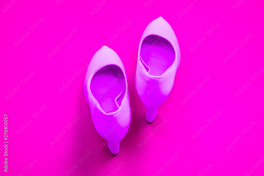 Pink high heeled shoes on pink purple background - top view - heels pointing up Pink high heeled shoes on pink purple background - top view - heels pointing up
