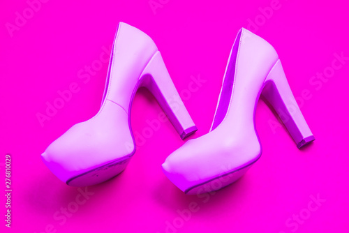 Pink high heeled shoes, pink purple background - top view - heels walking left