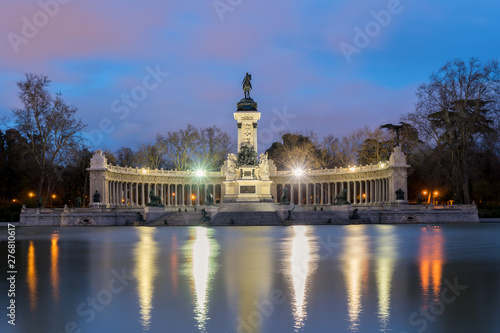 Night cityscape with lights at the memorial in Retiro city park, Madrid, Spain.