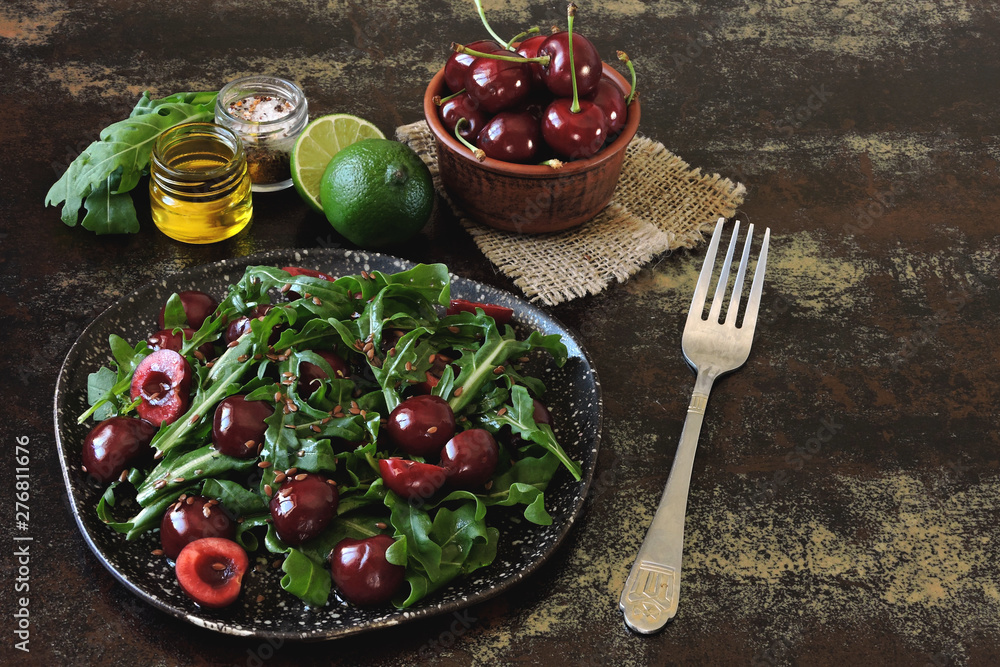Healthy dietary salad with sweet cherries and arugula. Fitness salad. Raw diet.